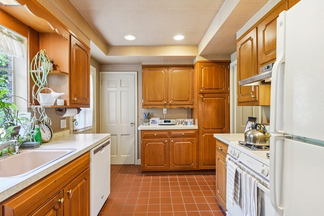21 Orchard Dr, East Williston, NY 11596 - kitchen featuring white appliances, light countertops, under cabinet range hood, dark tile patterned flooring, and plenty of natural light