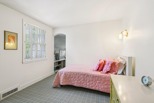 21 Orchard Dr, East Williston, NY 11596 - bedroom with dark carpet and arched walkways