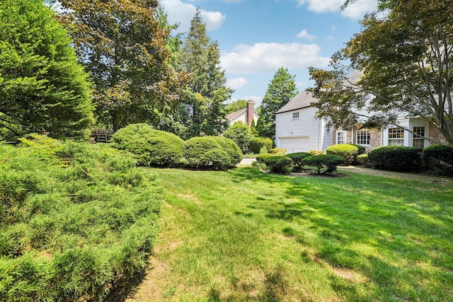 21 Orchard Dr, East Williston, NY 11596 - view of grassy yard with a garage