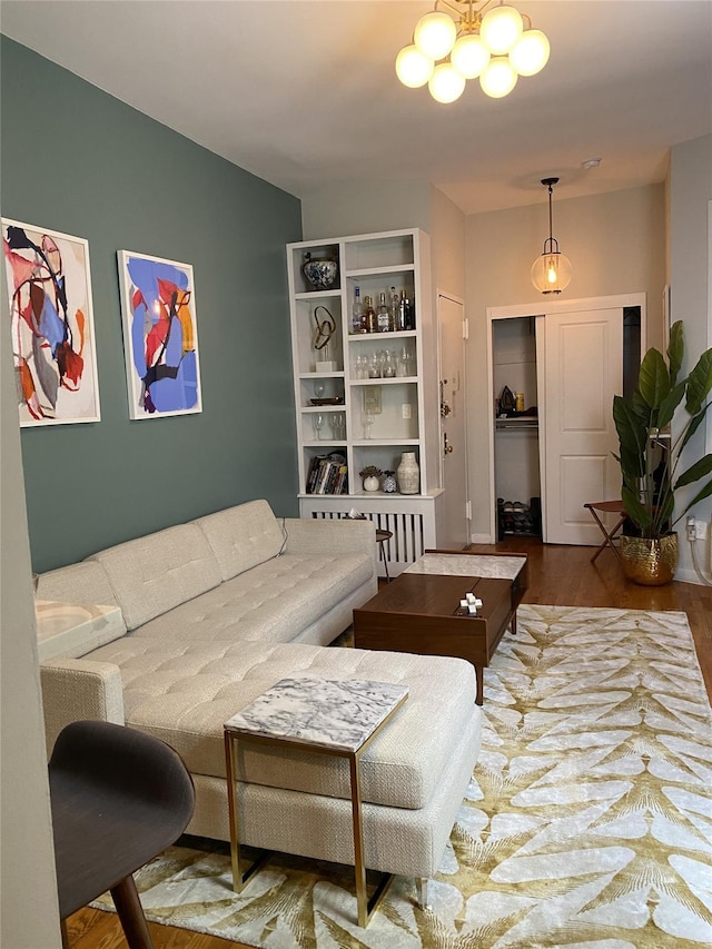 344 E 87th St Unit 3C, New York Manhattan, NY 10128 - living room featuring wood finished floors and a chandelier