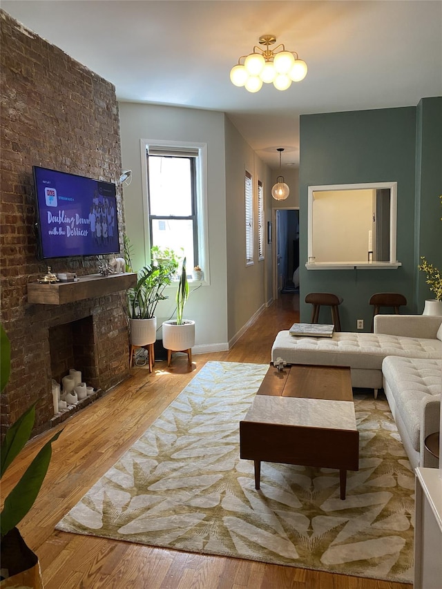 344 E 87th St Unit 3C, New York Manhattan, NY 10128 - living room featuring wood finished floors and a chandelier