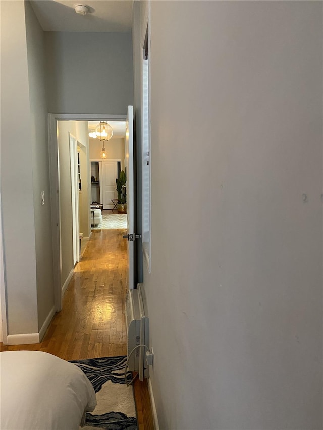 344 E 87th St Unit 3C, New York Manhattan, NY 10128 - corridor with light wood finished floors and a chandelier