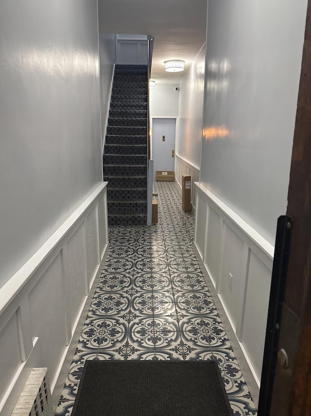 344 E 87th St Unit 3C, New York Manhattan, NY 10128 - hallway with a decorative wall, a wainscoted wall, and stairs