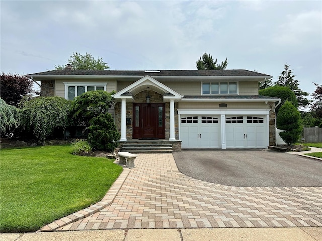 53 Orange Dr, Jericho, NY 11753 - view of front of home with driveway, stone siding, and a front yard