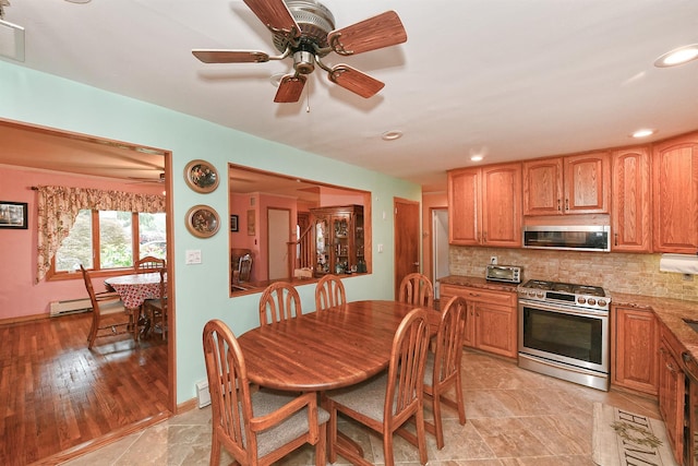 3665 Centerview Ave, Wantagh, NY 11793 - kitchen featuring appliances with stainless steel finishes, a baseboard heating unit, tasteful backsplash, ceiling fan, and recessed lighting