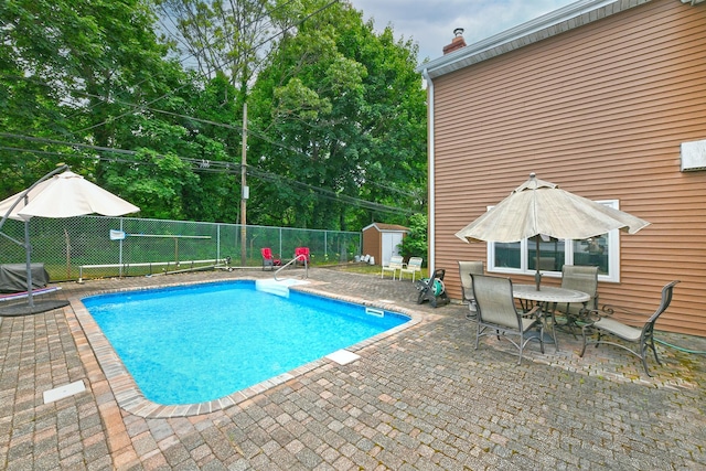 3665 Centerview Ave, Wantagh, NY 11793 - view of swimming pool featuring a storage unit, a patio, and outdoor dining area