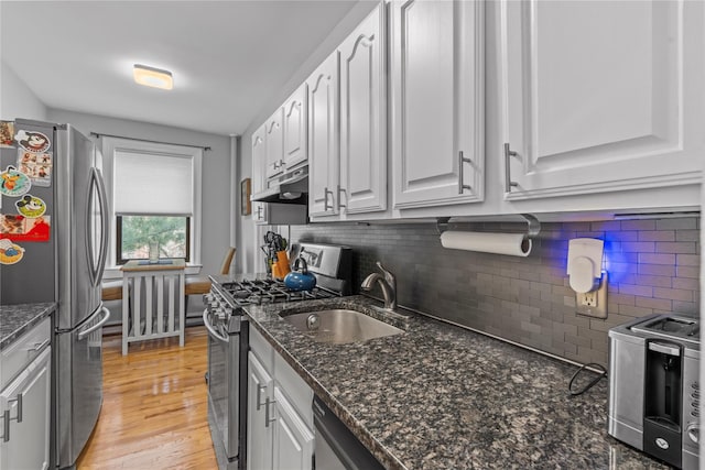 68 E Hartsdale Ave Unit 3K, Hartsdale, NY 10530 - kitchen featuring stainless steel appliances, white cabinetry, under cabinet range hood, and tasteful backsplash