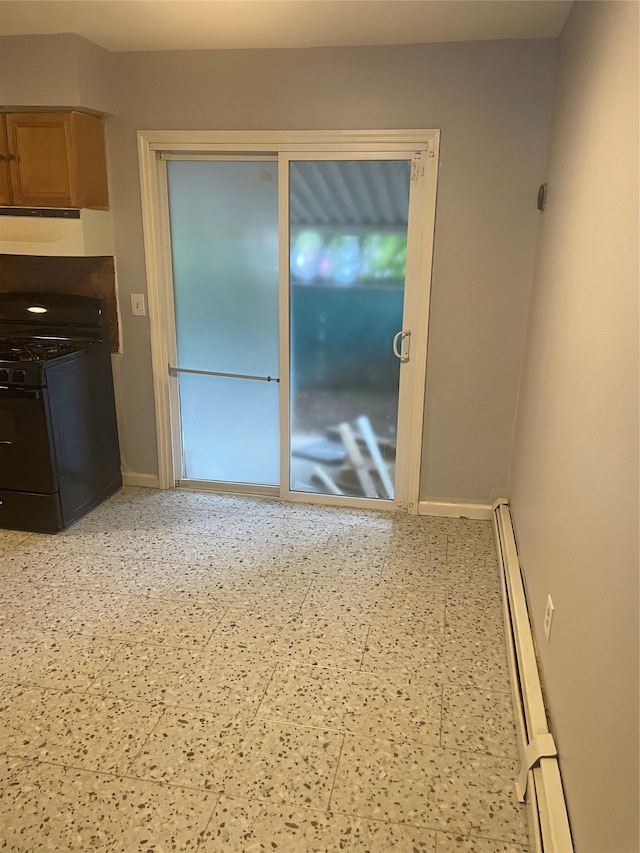 38 Sheffield Dr, Middletown, NY 10940 - kitchen with gas stove, under cabinet range hood, a baseboard radiator, and dark countertops