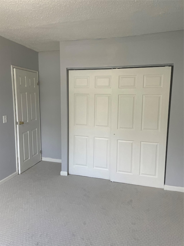 38 Sheffield Dr, Middletown, NY 10940 - unfurnished bedroom featuring carpet, a closet, and a textured ceiling