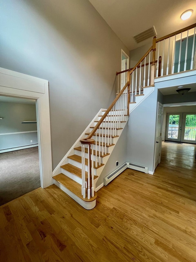 232 Minisink Tpke, Westtown, NY 10998 - staircase featuring a towering ceiling, baseboard heating, and wood finished floors