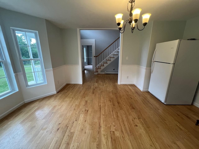 232 Minisink Tpke, Westtown, NY 10998 - unfurnished dining area featuring healthy amount of natural light, light wood-type flooring, a chandelier, and stairway