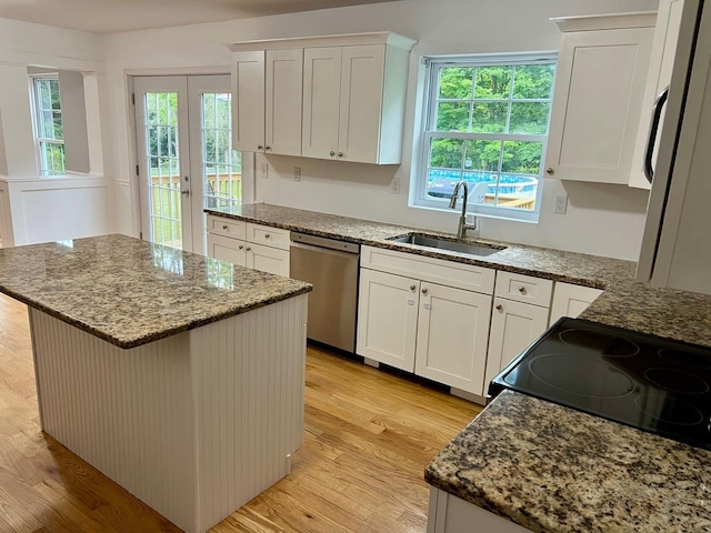 232 Minisink Tpke, Westtown, NY 10998 - kitchen with stainless steel dishwasher, a kitchen island, light wood-type flooring, and plenty of natural light