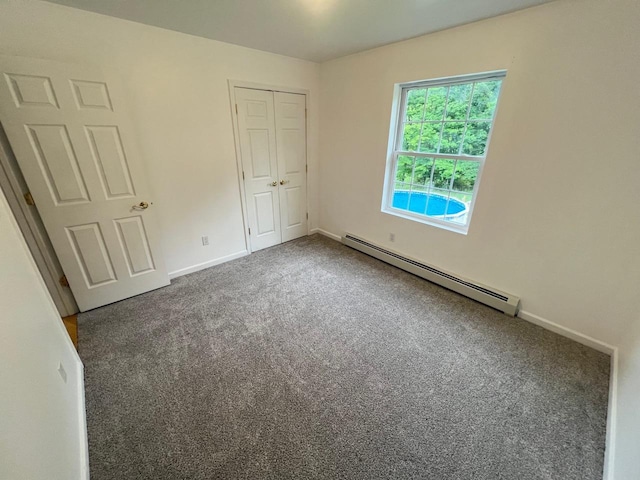 232 Minisink Tpke, Westtown, NY 10998 - unfurnished bedroom with a baseboard radiator, carpet, and a closet