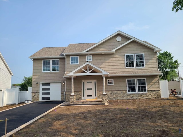 56 Bayberry Ln, Levittown, NY 11756 - craftsman-style house with stone siding, a garage, asphalt driveway, and roof with shingles