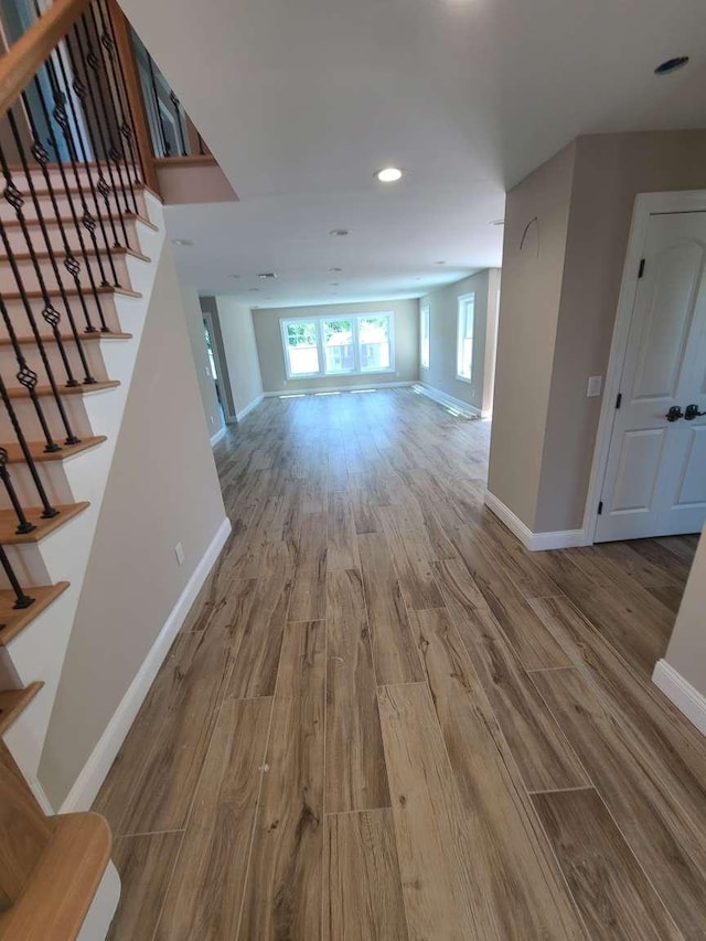56 Bayberry Ln, Levittown, NY 11756 - corridor with wood finished floors, stairway, and recessed lighting