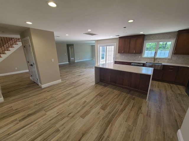 56 Bayberry Ln, Levittown, NY 11756 - kitchen featuring open floor plan, light countertops, light wood-type flooring, a kitchen island, and recessed lighting