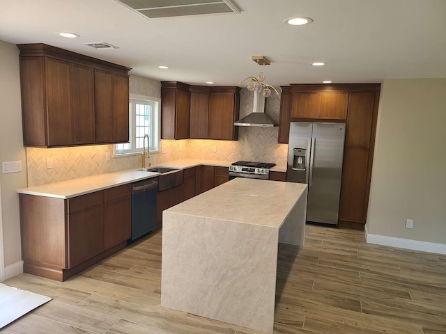 56 Bayberry Ln, Levittown, NY 11756 - kitchen featuring stainless steel appliances, wall chimney exhaust hood, tasteful backsplash, recessed lighting, and light wood finished floors