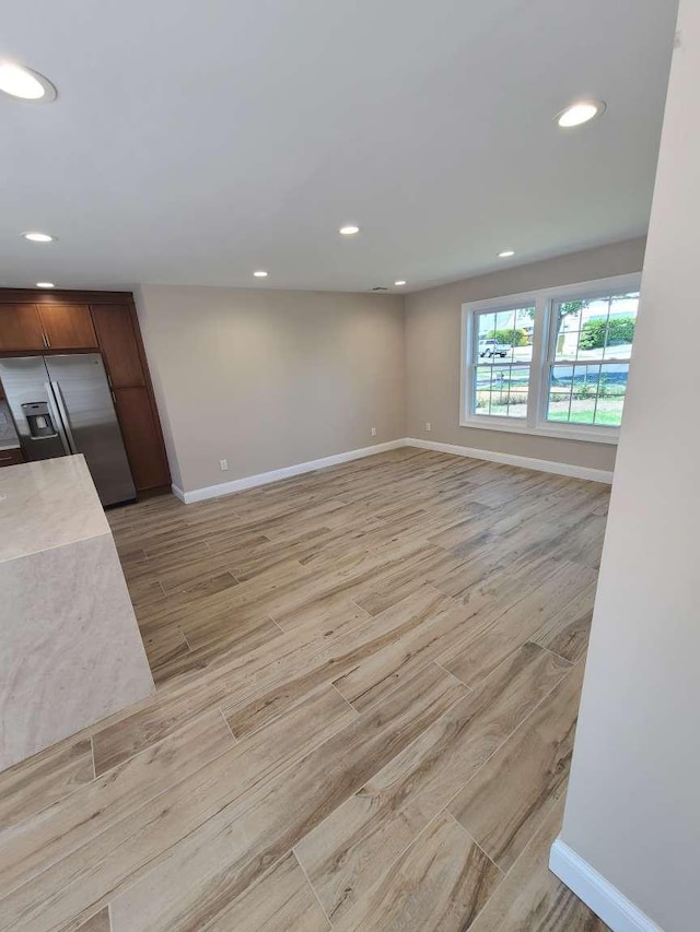 56 Bayberry Ln, Levittown, NY 11756 - unfurnished living room featuring light wood-type flooring and recessed lighting