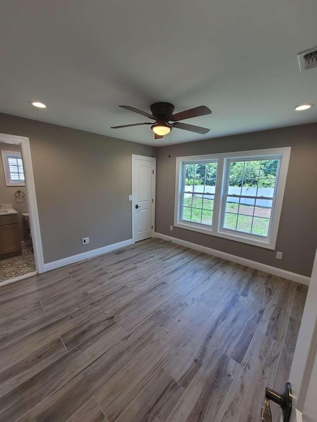 56 Bayberry Ln, Levittown, NY 11756 - spare room with healthy amount of natural light, wood finished floors, a ceiling fan, and recessed lighting