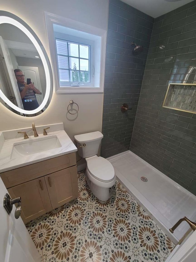 56 Bayberry Ln, Levittown, NY 11756 - bathroom with tiled shower, vanity, and tile patterned flooring
