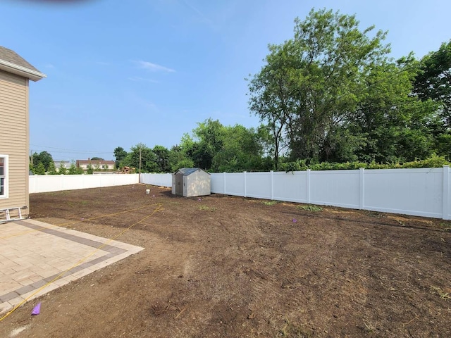 56 Bayberry Ln, Levittown, NY 11756 - fenced backyard with a storage unit and a patio area