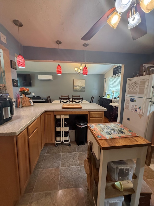 7 Walnut Ct, Goshen, NY 10924 - kitchen with an AC wall unit, a center island, dark stone finish flooring, and decorative light fixtures