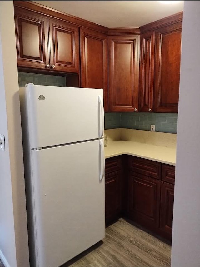 124 Smith St Unit 3B, Freeport, NY 11520 - kitchen featuring freestanding refrigerator, light countertops, backsplash, and light wood finished floors