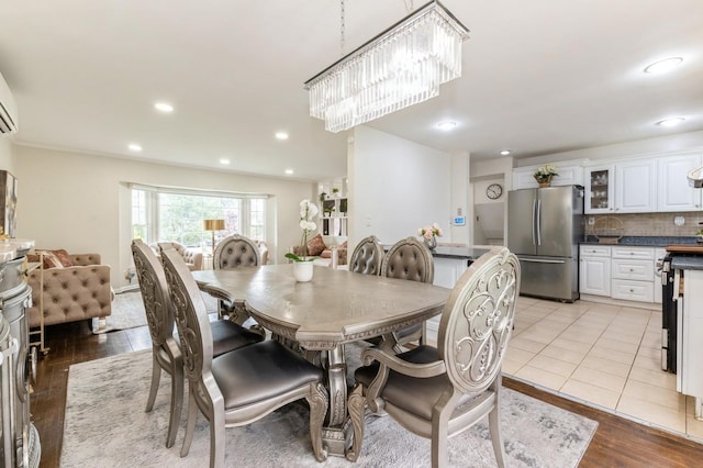 114 Birchwood Park Dr, Syosset, NY 11791 - dining room with recessed lighting, a chandelier, and light wood-type flooring