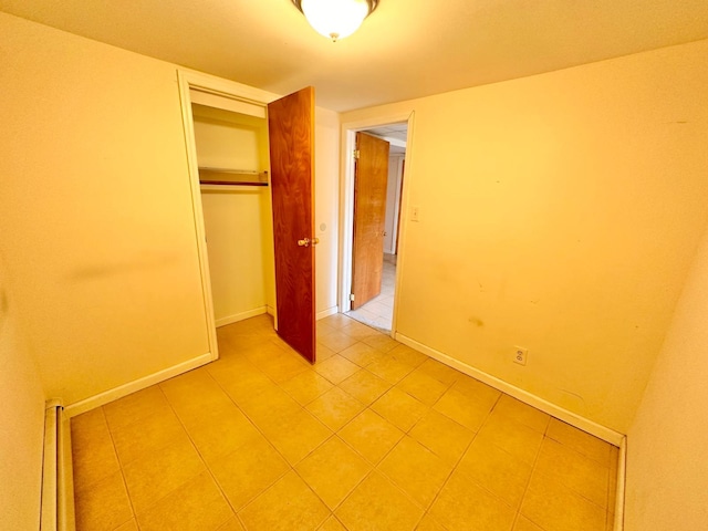 114 Birchwood Park Dr, Syosset, NY 11791 - unfurnished bedroom with light tile patterned floors and a closet