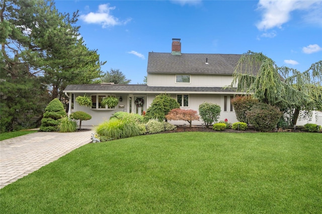 55 Duckpond Dr N, Wantagh, NY 11793 - view of front of property with a chimney, a front yard, and roof with shingles