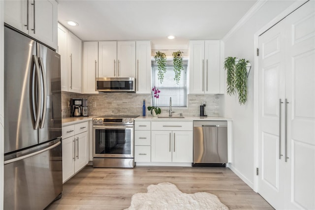 55 Duckpond Dr N, Wantagh, NY 11793 - kitchen with appliances with stainless steel finishes, light countertops, tasteful backsplash, recessed lighting, and white cabinets