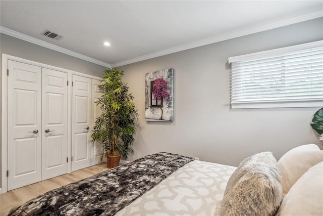 55 Duckpond Dr N, Wantagh, NY 11793 - bedroom with light wood finished floors, crown molding, two closets, and recessed lighting