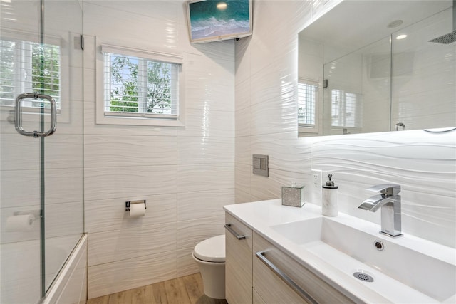 55 Duckpond Dr N, Wantagh, NY 11793 - bathroom with tile walls, vanity, shower / bath combination with glass door, and wood finished floors