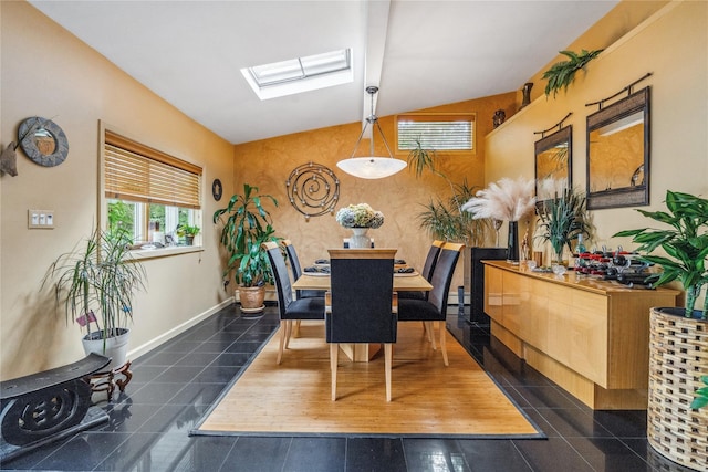 55 Duckpond Dr N, Wantagh, NY 11793 - dining room featuring a skylight, lofted ceiling, and dark tile patterned flooring