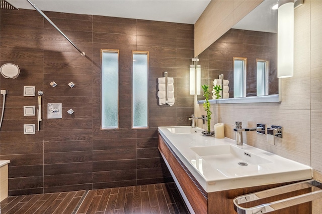 55 Duckpond Dr N, Wantagh, NY 11793 - bathroom featuring double vanity, plenty of natural light, a tile shower, and tile walls