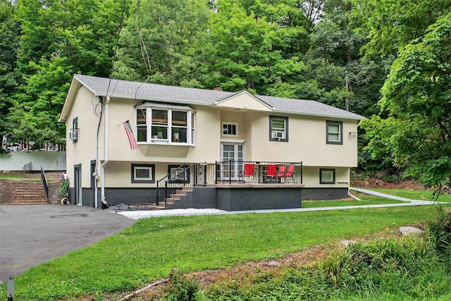 411 Fair Oaks Rd, Middletown, NY 10940 - raised ranch with stucco siding, a front yard, and stairs