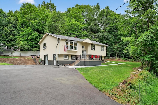 411 Fair Oaks Rd, Middletown, NY 10940 - raised ranch with a trampoline, stucco siding, and a front lawn