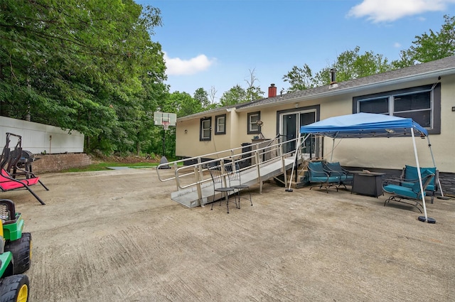 411 Fair Oaks Rd, Middletown, NY 10940 - ranch-style house featuring a fire pit, a patio, stucco siding, and a chimney