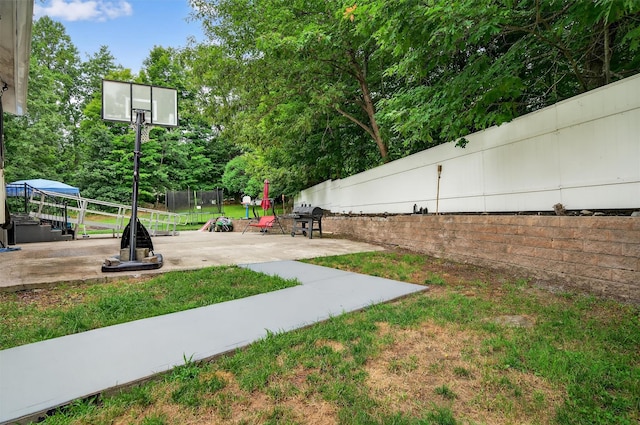 411 Fair Oaks Rd, Middletown, NY 10940 - view of yard featuring a trampoline, a patio, and view of wooded area