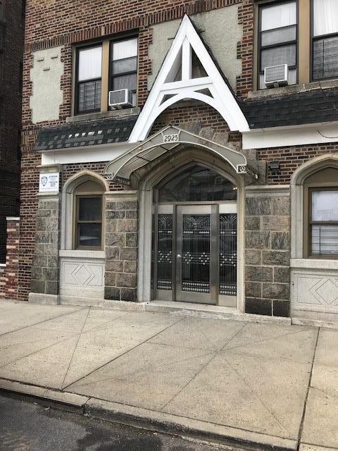 2925 Matthews Ave Unit 5F, Bronx, NY 10467 - property entrance with brick siding, cooling unit, and stone siding