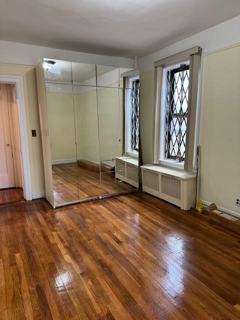 2925 Matthews Ave Unit 5F, Bronx, NY 10467 - unfurnished bedroom featuring wood-type flooring, radiator heating unit, and a closet