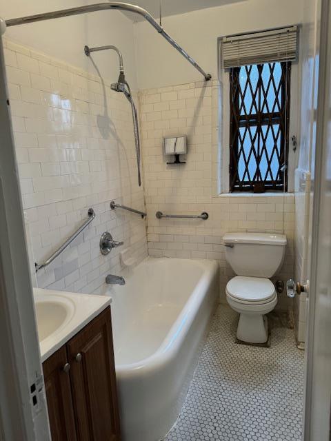 2925 Matthews Ave Unit 5F, Bronx, NY 10467 - full bathroom with  shower combination, tile walls, vanity, and tile patterned flooring