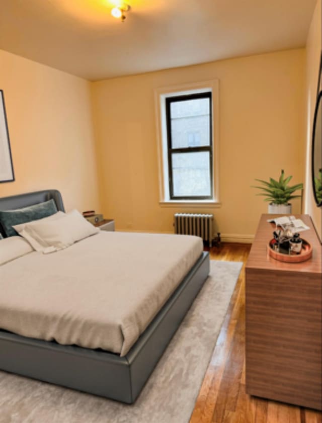 2925 Matthews Ave Unit 5F, Bronx, NY 10467 - bedroom with radiator and wood finished floors