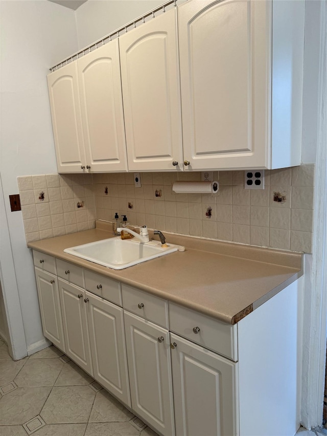 2925 Matthews Ave Unit 5F, Bronx, NY 10467 - kitchen with decorative backsplash, white cabinets, light tile patterned floors, and light countertops