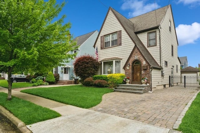 445 Wellington Rd, Mineola, NY 11501 - tudor-style house with roof with shingles