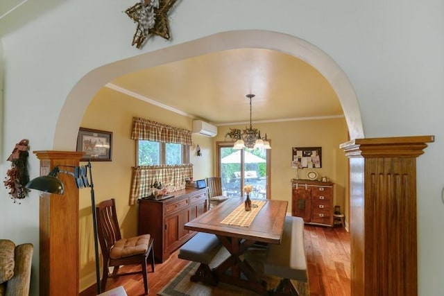 445 Wellington Rd, Mineola, NY 11501 - dining area with an AC wall unit, arched walkways, wood finished floors, ornamental molding, and a chandelier