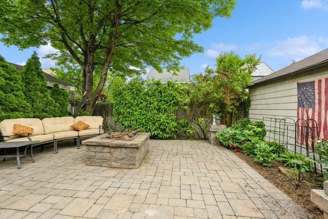 445 Wellington Rd, Mineola, NY 11501 - fenced backyard with a patio and an outdoor living space with a fire pit