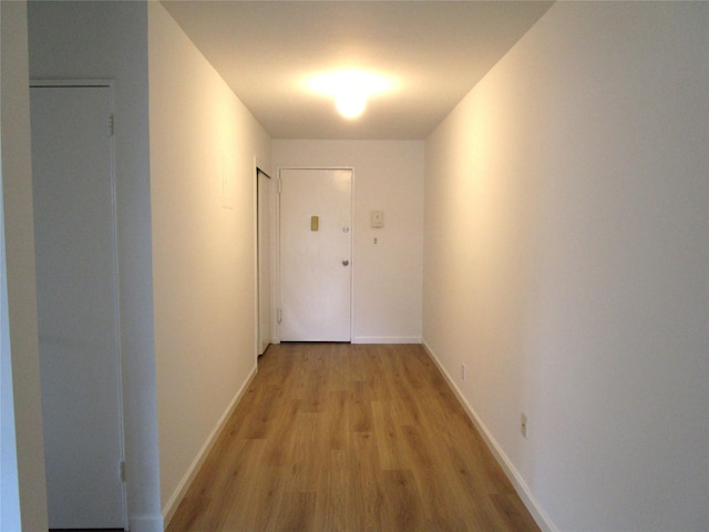 324 Post Ave Apt 8-J, Westbury, NY 11590 - hallway featuring light wood-type flooring and baseboards