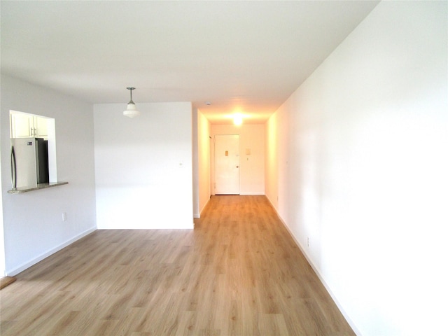 324 Post Ave Apt 8-J, Westbury, NY 11590 - unfurnished room featuring light wood-style floors and baseboards