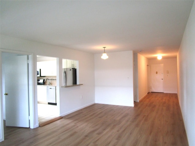 324 Post Ave Apt 8-J, Westbury, NY 11590 - empty room featuring wood finished floors and a sink
